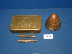 A Brass "Princess Mary" 1914 Christmas Tin containing two dummy Lee Enfield bullets and the brass