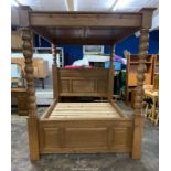 A heavy Oak four poster Bedstead having a raised and fielded panelled headboard,