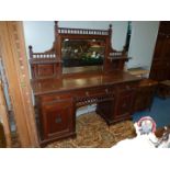 An Edwardian Mahogany/Walnut Sideboard having three frieze drawers,