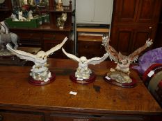 Three owl figures from The Juliana Collection.