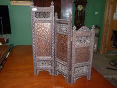 An early and surprisingly heavy beautifully worked three-fold Table Screen in dark and oak and