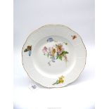 A pretty Meissen plate with basket weave design rim and flowers and butterfly decoration gilt edge,