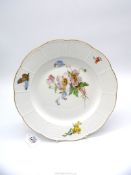 A pretty Meissen plate with basket weave design rim and flowers and butterfly decoration gilt edge,