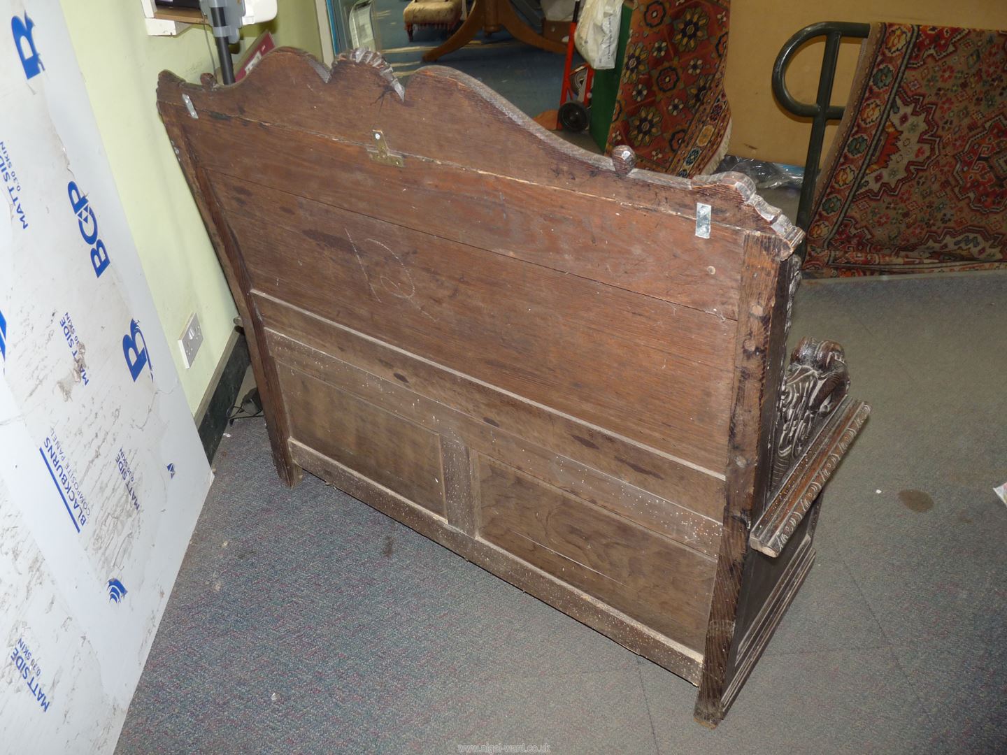 A profusely carved Oak Hall locker base Settle, the backrest with depictions of Phoenixes, - Image 2 of 9