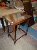 A rectangular Oak occasional Table standing on twist legs with perimeter stretchers,