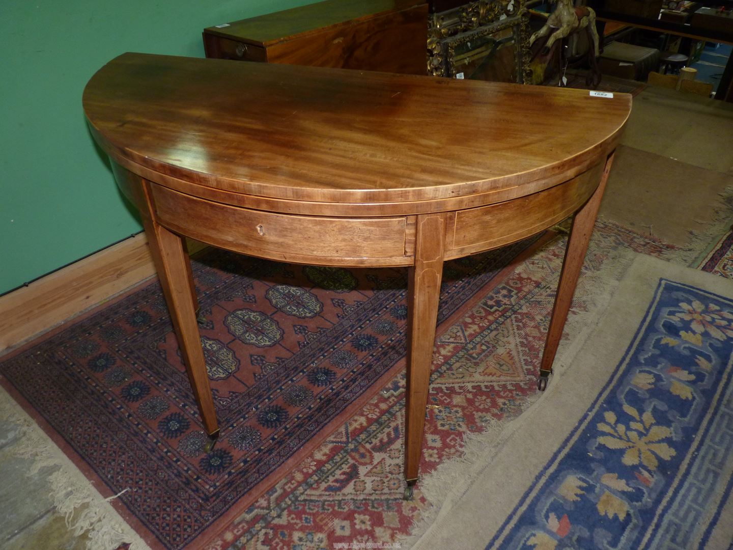 An 18th Century Georgian Mahogany double swing-leg fold-over Tea Table of high quality having