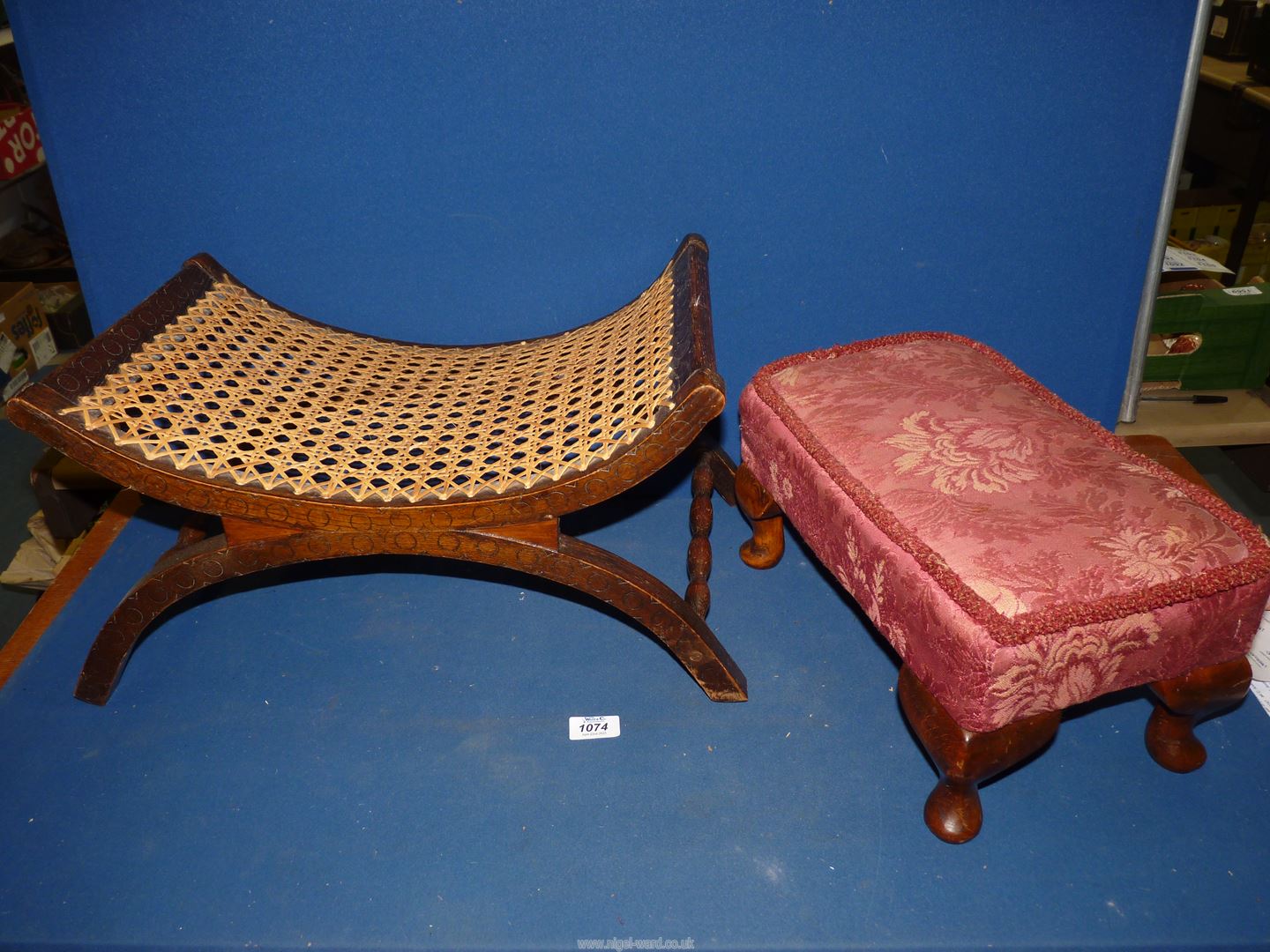 A low Oak stool with curved cane seat with carved details,