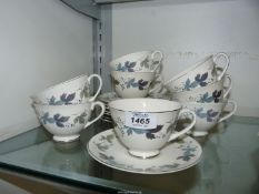 Eight Royal Doulton cups and saucers in 'Burgundy' pattern.