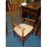 An elegant mixed woods Arts and crafts design open armed Elbow Chair having a fretworked central