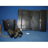 A pair of cased Prinzlux extralite 7 x 50 Binoculars and a black leather folio case.