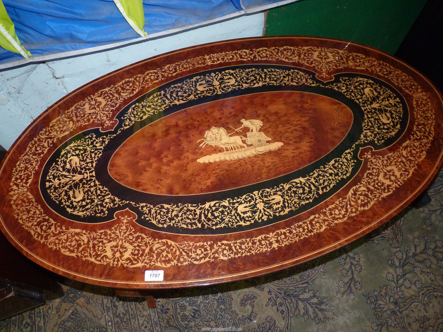 An oval continental low Occasional Table having a central depiction of a Roman Charioteer with a - Image 2 of 4