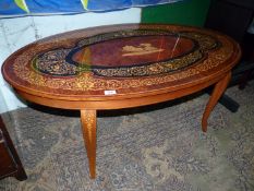 An oval continental low Occasional Table having a central depiction of a Roman Charioteer with a