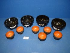 Four lacquered bowls with dragonfly pattern and six lacquered egg cups.