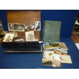 A quantity of Postcards and Photographs in a wooden box.