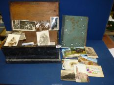 A quantity of Postcards and Photographs in a wooden box.