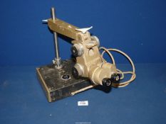 An illuminating Binocular Microscope having a very heavily weighted base,