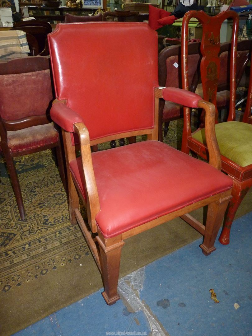 An Oak framed deep red upholstered office Armchair standing on tapering square legs and with "H"