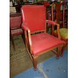 An Oak framed deep red upholstered office Armchair standing on tapering square legs and with "H"