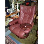 An Ekornes Stressless burgundy hide upholstered reclining Armchair in very good order and having an