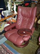 An Ekornes Stressless burgundy hide upholstered reclining Armchair in very good order and having an
