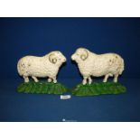 A pair of painted cast iron Doorstops modelled as sheep, 9'' wide x 6 3/4'' high.