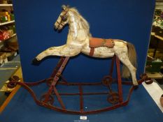 A French 19th century carved Rocking horse, 24 1/4'' high overall, with metal fittings,