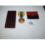 An Indian General Headquarters woven cloth Formation Badge and a Somme Combattants Medal