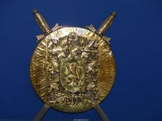 A brass wall mounted Shield with crest Armorial and Swords.
