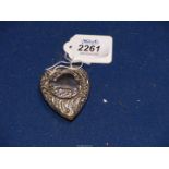 An ornate plated heart shaped Snuff box with scrolls and floral decoration having gilded interior.