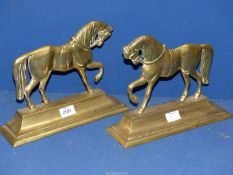 A pair of Brass Doorstops in the form of horses.
