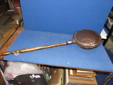 A copper bed warming pan.