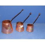 Three copper jugs.