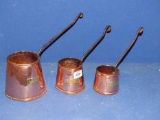 Three copper jugs.