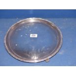 A large Silver circular serving Platter on three feet with geometric pattern rim, Sheffield 1937,