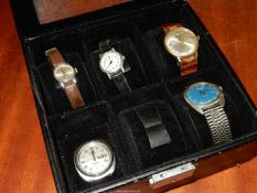 A watch dispaly case containing Five watches including an Avia 17 jewels incabloc gents watch with