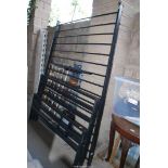 A black metal double bed frame.