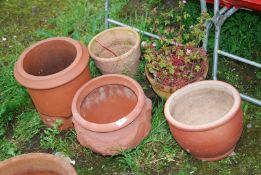 A terracotta chimney pot and other pots.