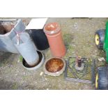 A chicken feeder, top of water feeder, chimney pot and parasol base.