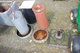 A chicken feeder, top of water feeder, chimney pot and parasol base.