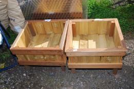 A pair of wooden planters, 21 1/2'' x 16'' high.