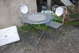 A metal circular folding table, 27 1/2'' diameter x 28'' high and matching pair of chairs.