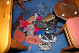 A quantity of handbags, some leather.