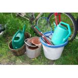 A galvanised wash bucket, two watering cans, tennis racquet etc.