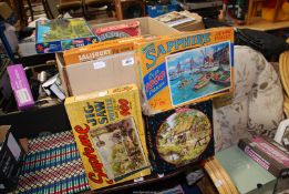 A quantity of mixed jigsaw puzzles.