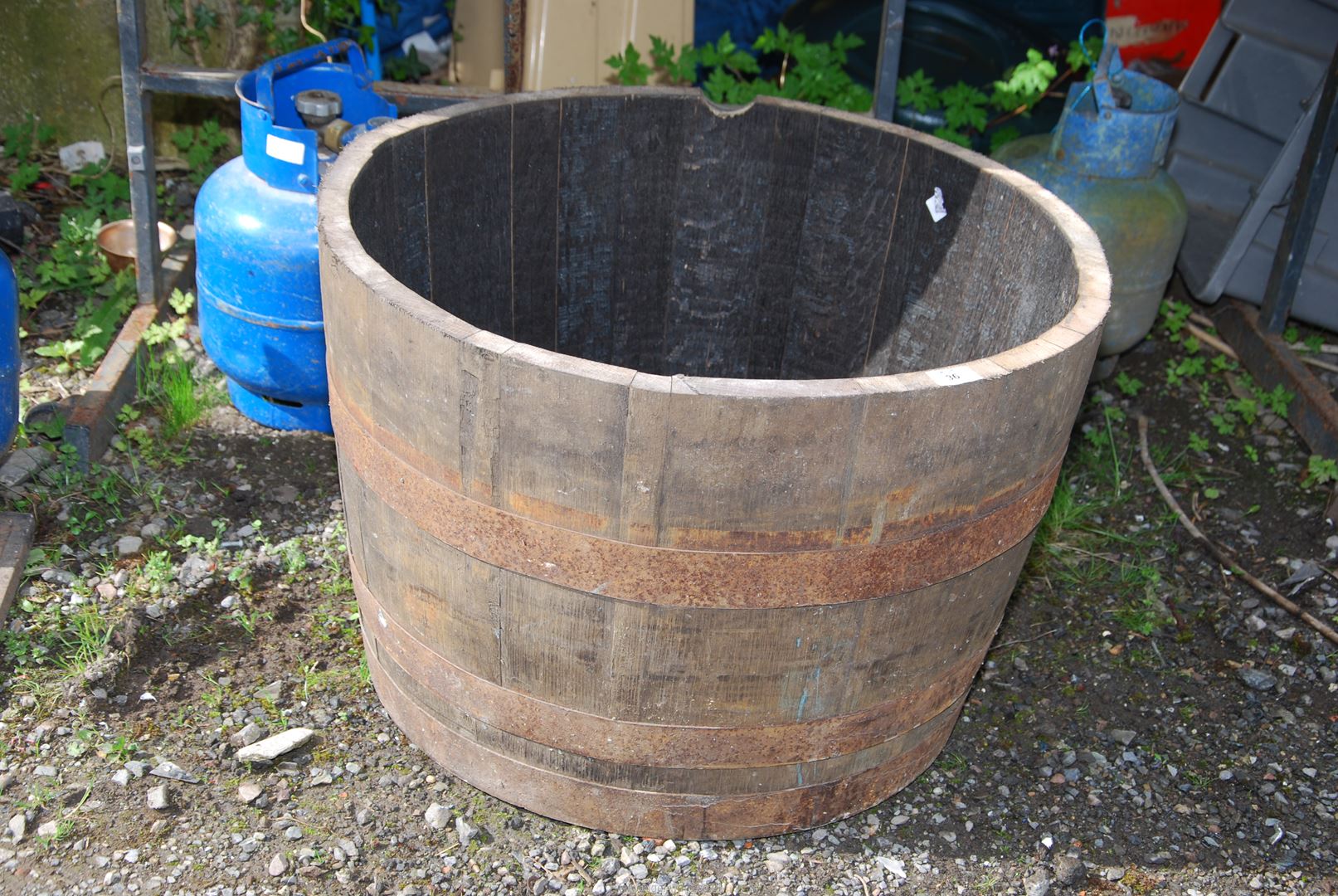 A half whisky barrel, 25'' diameter x 16 1/2'' high.