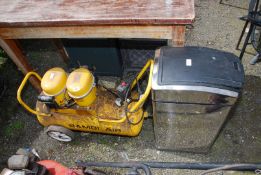 A Bambi (NOT working at time of lotting) air compressor and a waste bin.