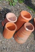 Four terracotta chimney pots.