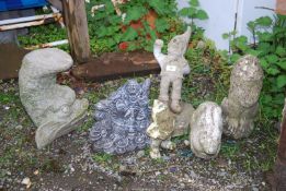 Small concrete Lion, rabbit, gnome and fish garden ornaments.