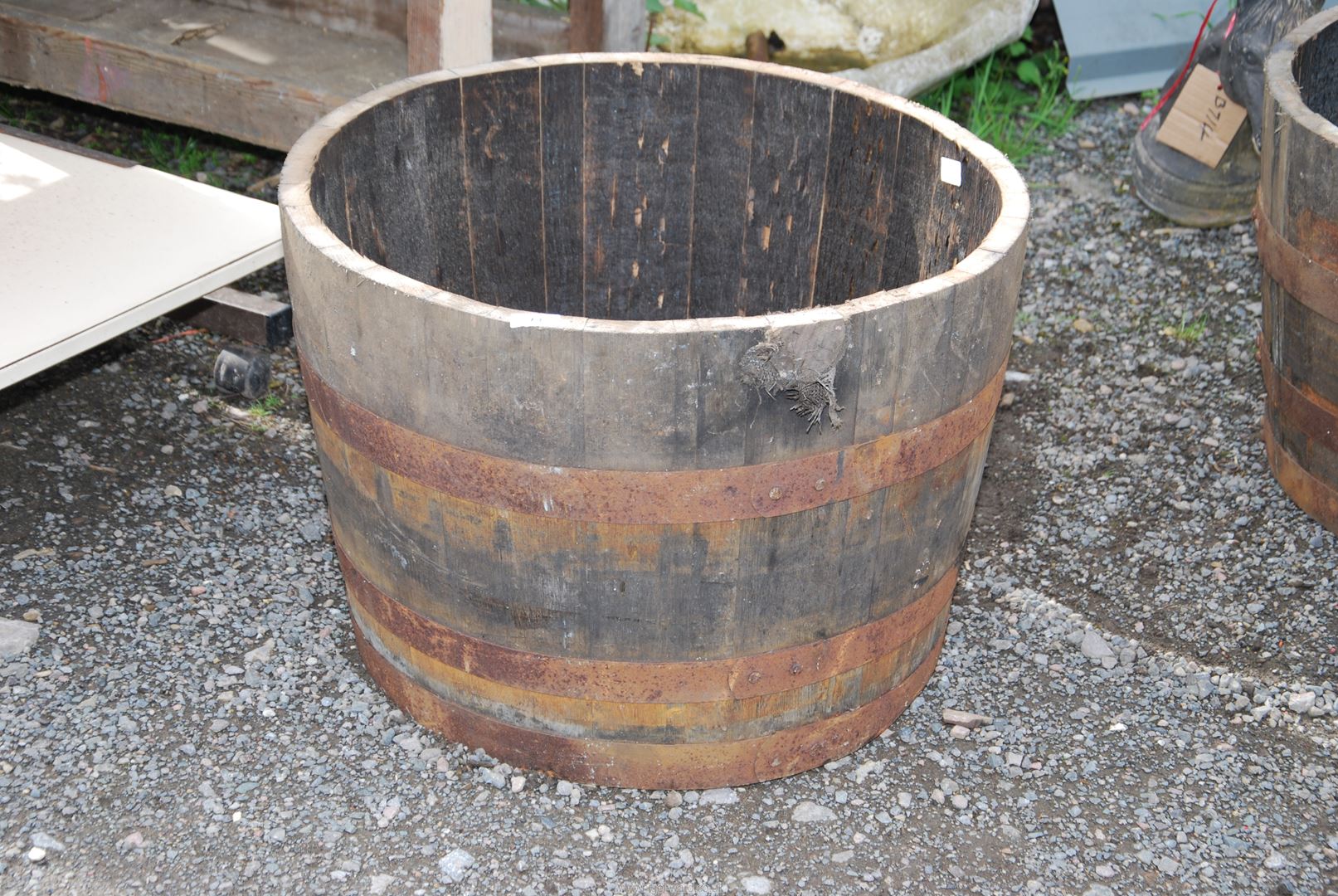 A half whisky barrel, 25 1/2'' diameter x 17 1/2'' high.