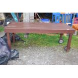 A painted Garden table with wheels to one end and handle, with cover, 74'' x 32'' x 29''.